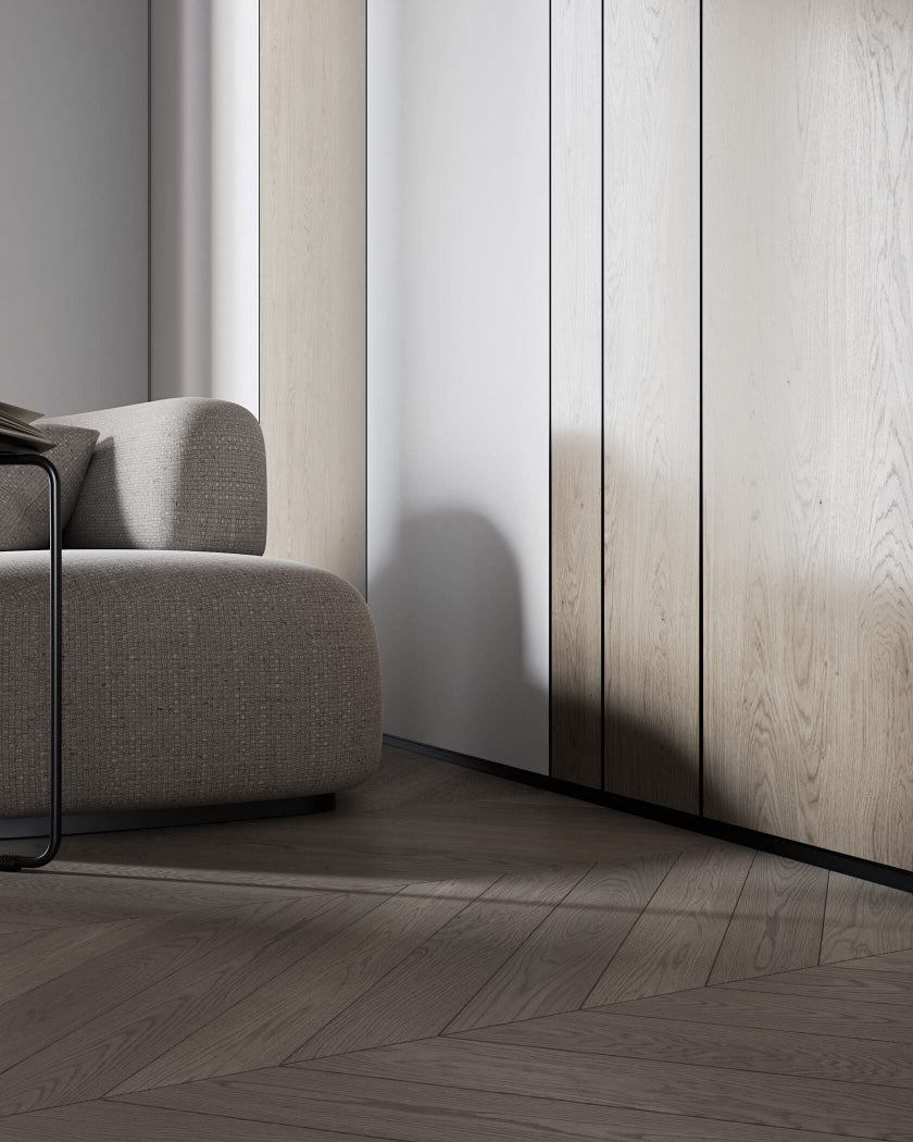 Aluminium baseboard and separator with shadow gap in minimalistic interior. 